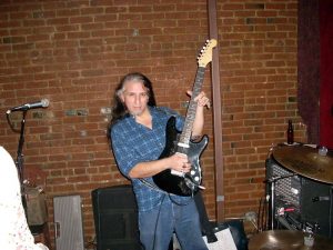 Rikki Rocket with one of his beloved guitars.